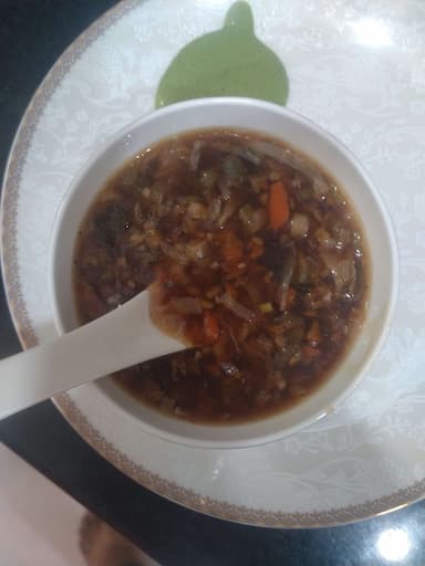 Tasty Vegetable Manchow Soup cooked by COOX chefs cooks during occasions parties events at home