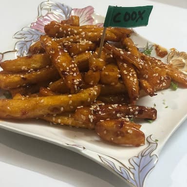 Tasty Honey Chilli Potato cooked by COOX chefs cooks during occasions parties events at home