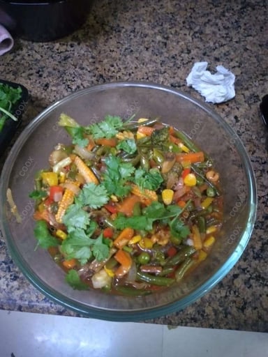 Tasty Mix Veg in Schezwan Sauce cooked by COOX chefs cooks during occasions parties events at home
