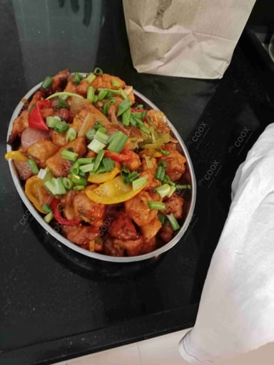 Tasty Chilli Chicken cooked by COOX chefs cooks during occasions parties events at home