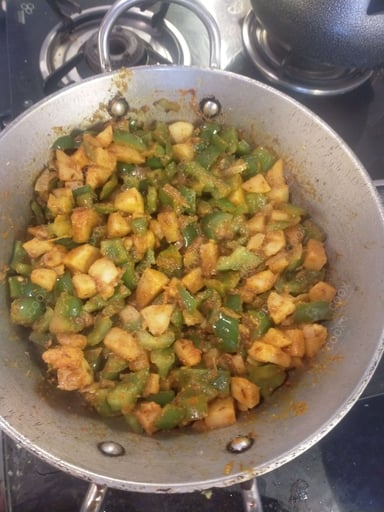 Tasty Aloo Shimla Mirch cooked by COOX chefs cooks during occasions parties events at home