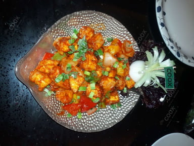 Tasty Chilli Paneer (Dry) cooked by COOX chefs cooks during occasions parties events at home