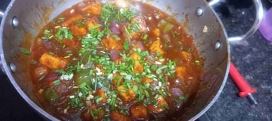 Tasty Chilli Paneer (Gravy) cooked by COOX chefs cooks during occasions parties events at home