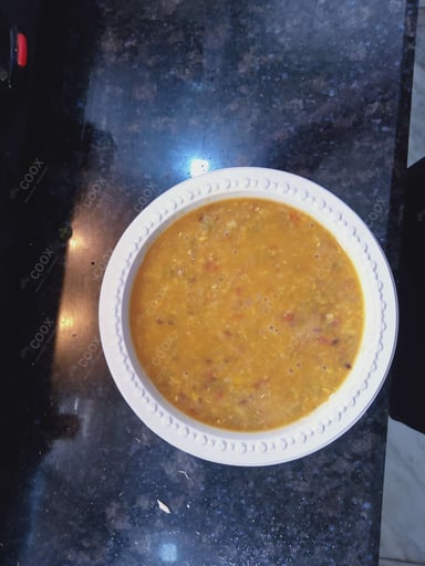 Tasty Dal Tadka cooked by COOX chefs cooks during occasions parties events at home