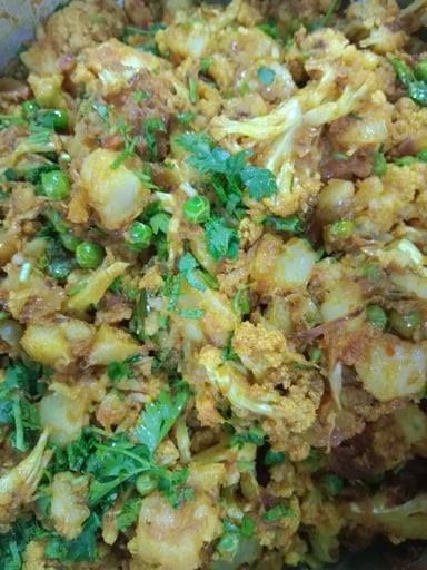 Tasty Gobhi Matar cooked by COOX chefs cooks during occasions parties events at home