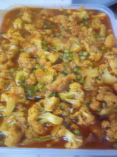 Tasty Gobhi Matar cooked by COOX chefs cooks during occasions parties events at home