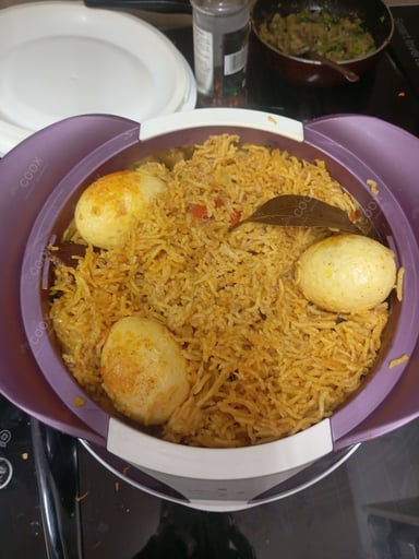 Tasty Egg Biryani cooked by COOX chefs cooks during occasions parties events at home