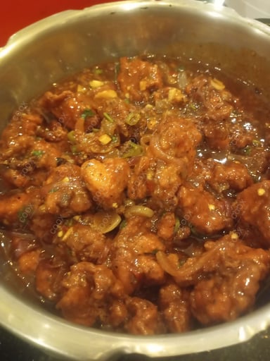 Tasty Chicken in Schezwan Sauce cooked by COOX chefs cooks during occasions parties events at home