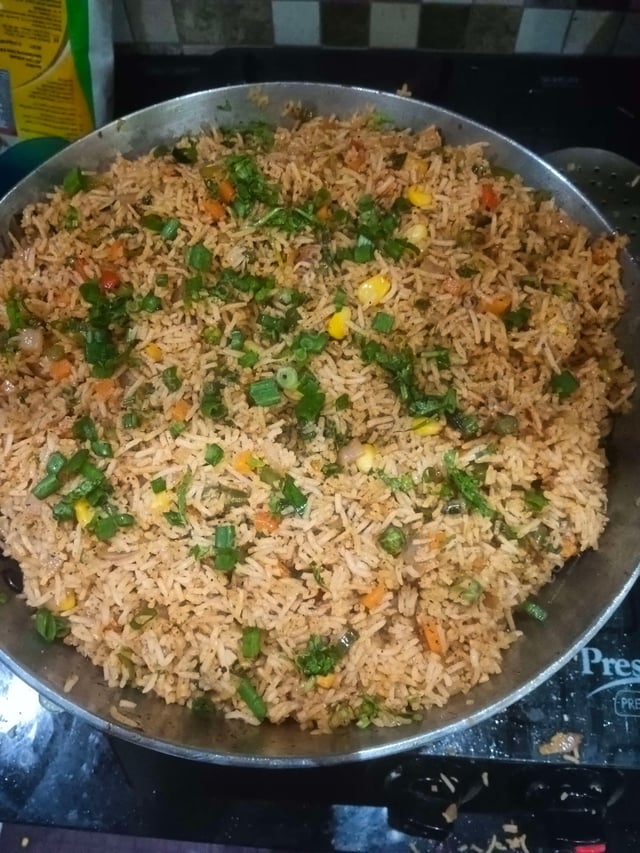 Delicious Schezwan Fried Rice prepared by COOX