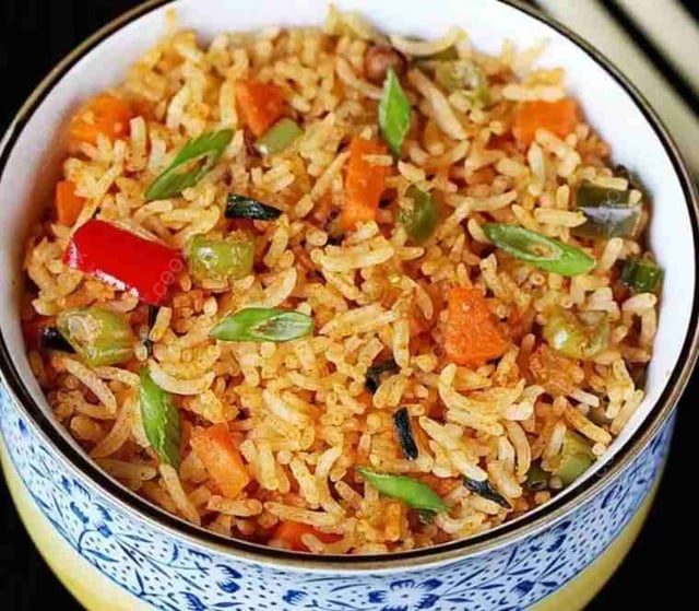 Delicious Schezwan Fried Rice prepared by COOX