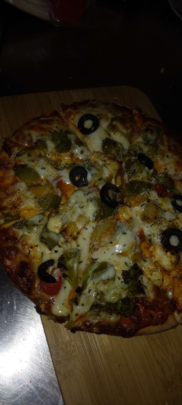 Delicious Veg Pizza prepared by COOX