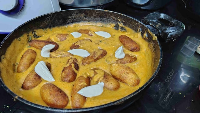 Delicious Malai Kofta (Orange Gravy) prepared by COOX