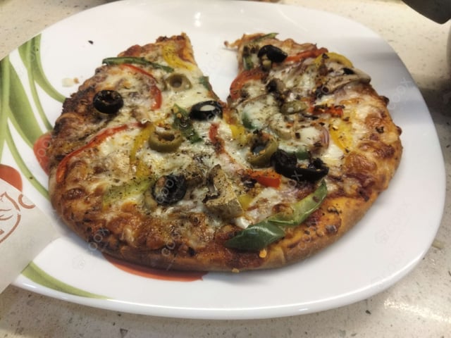 Delicious Veg Pizza prepared by COOX